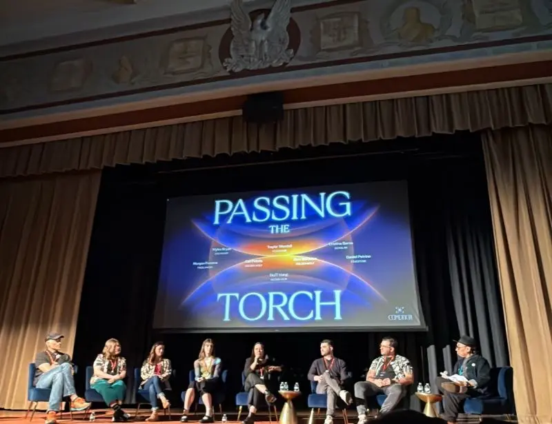 CoMotion identity on the stage screen during the “Passing the Torch” panel